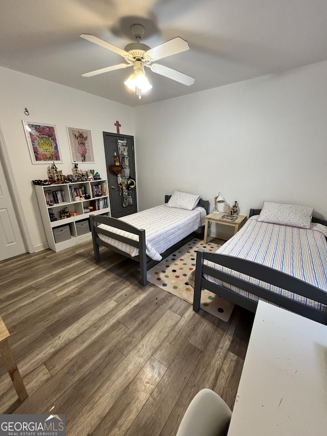 bedroom with ceiling fan and hardwood / wood-style flooring