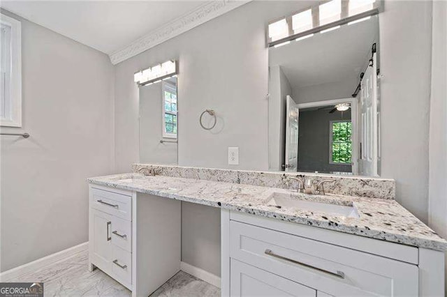 bathroom featuring ceiling fan and vanity