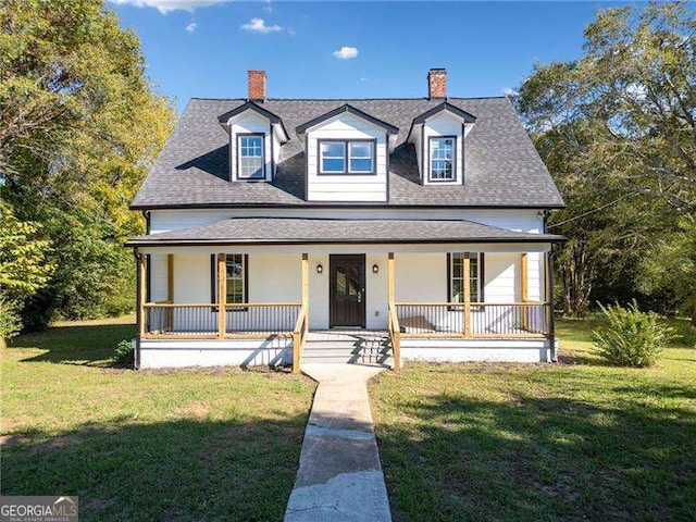 view of front of house with covered porch and a front yard