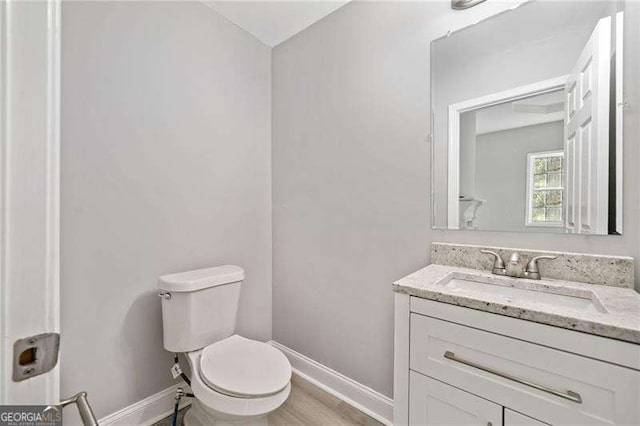 bathroom featuring toilet and vanity