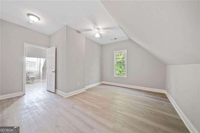 additional living space with vaulted ceiling, ceiling fan, and light hardwood / wood-style flooring