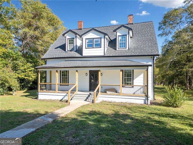 view of front of property with covered porch and a front yard