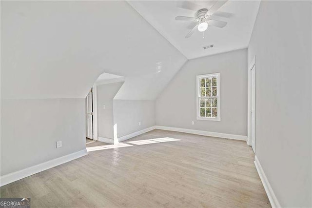 bonus room featuring ceiling fan, vaulted ceiling, and light wood-type flooring