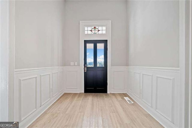 foyer entrance featuring light wood-type flooring and plenty of natural light