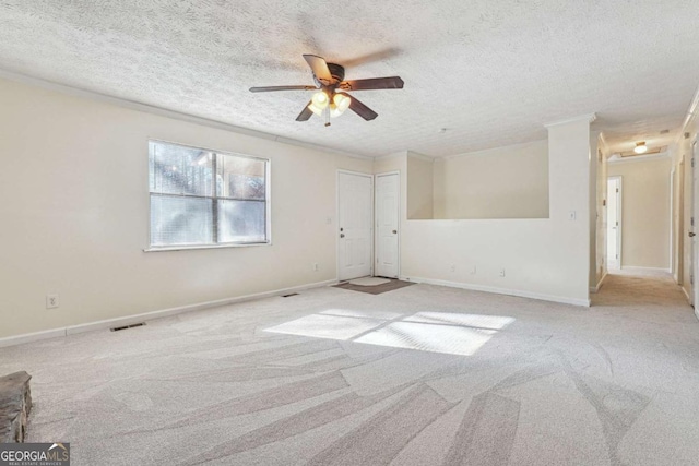 carpeted spare room featuring ceiling fan and a textured ceiling