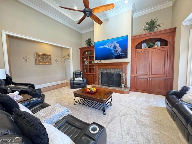 living room featuring ceiling fan, crown molding, and a towering ceiling