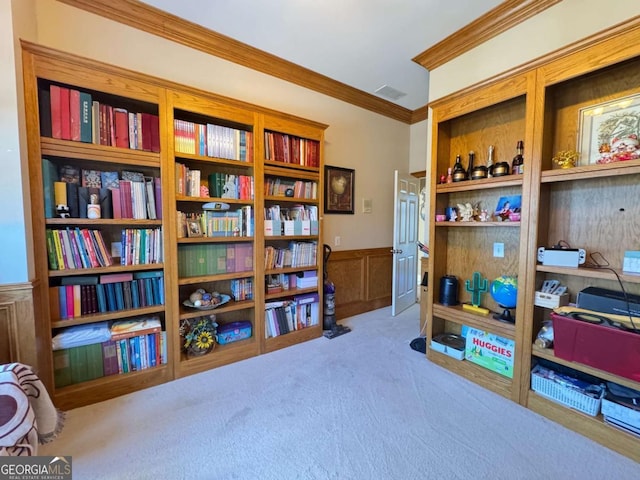 interior space featuring ornamental molding and carpet flooring