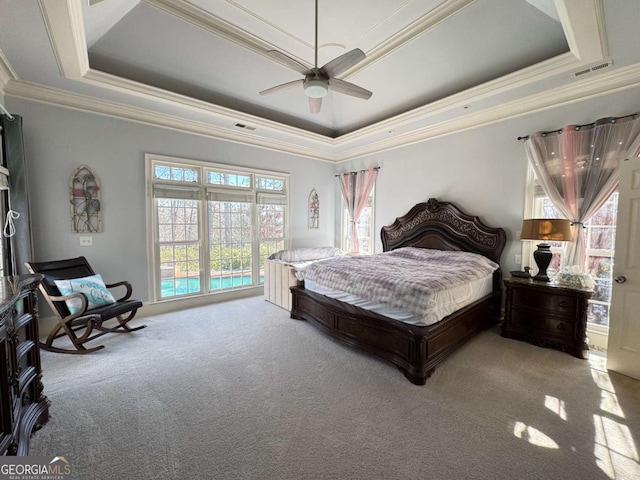 carpeted bedroom with ceiling fan, access to exterior, crown molding, and a raised ceiling