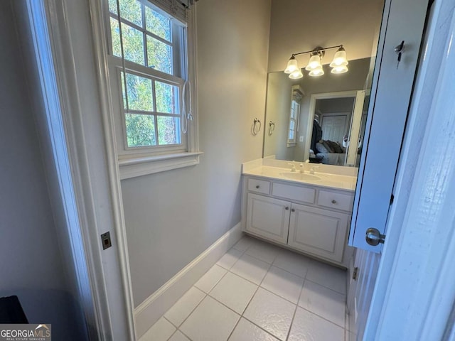 bathroom featuring tile patterned flooring, vanity, and a healthy amount of sunlight