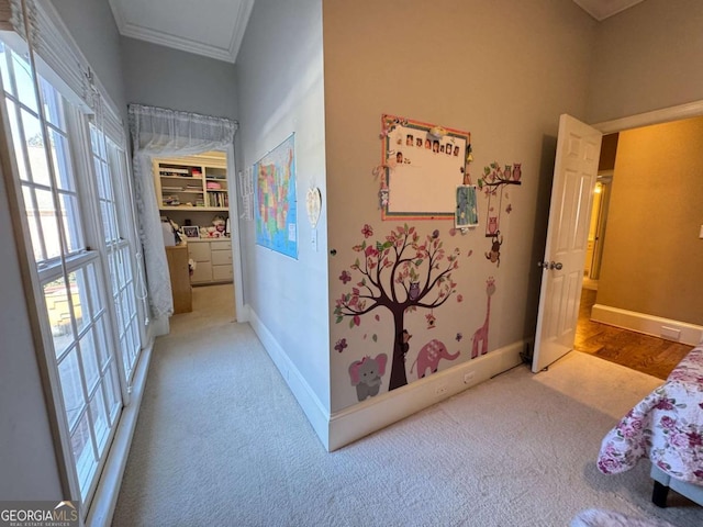 corridor with crown molding and light colored carpet