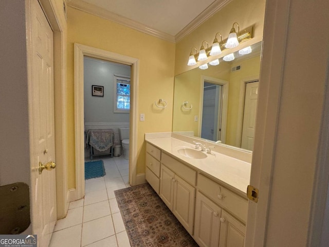 bathroom featuring toilet, ornamental molding, tile patterned floors, and vanity