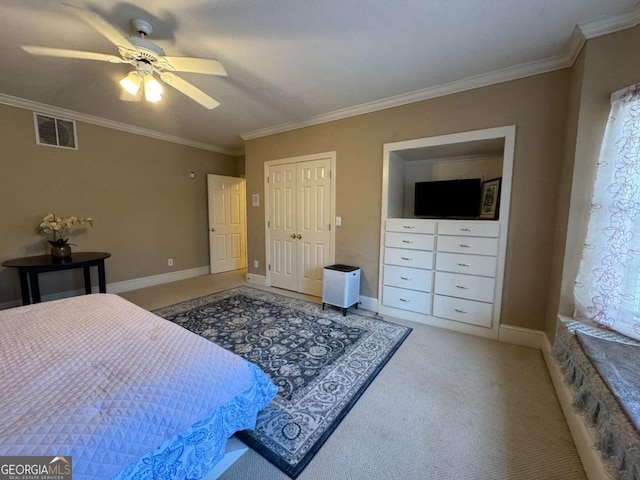 carpeted bedroom featuring ceiling fan and crown molding