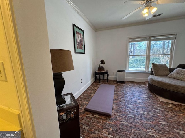 living room featuring ceiling fan and ornamental molding