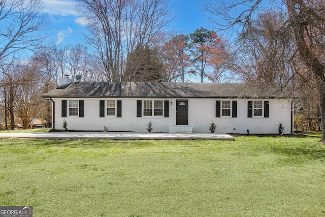 ranch-style home featuring a front lawn, crawl space, a chimney, and brick siding