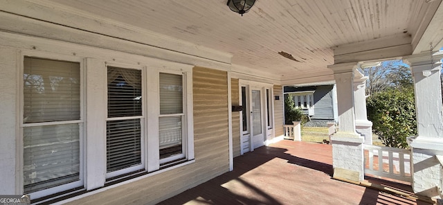 wooden terrace featuring covered porch