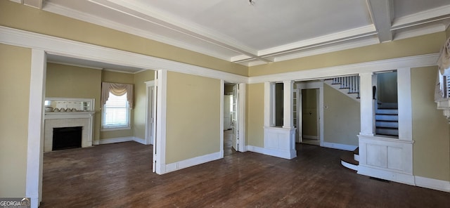 unfurnished room featuring coffered ceiling, dark wood-type flooring, a fireplace, crown molding, and beam ceiling