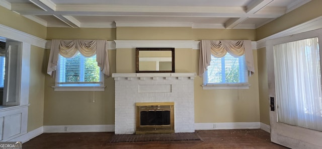 unfurnished living room featuring beam ceiling, a healthy amount of sunlight, a fireplace, and coffered ceiling