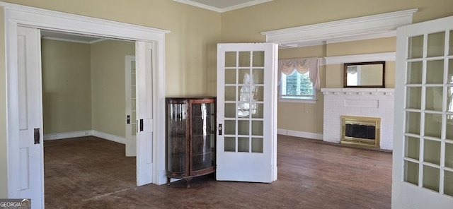 interior space with a brick fireplace, crown molding, and french doors