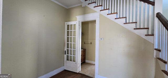 staircase featuring crown molding and hardwood / wood-style floors