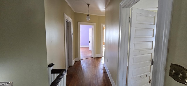 hallway with ornamental molding and dark hardwood / wood-style flooring