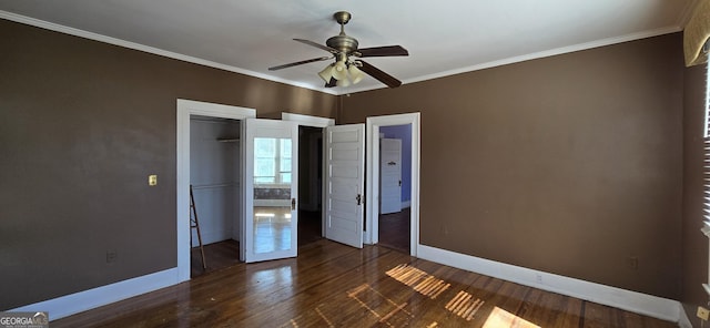 unfurnished bedroom with ceiling fan, ornamental molding, a closet, and dark hardwood / wood-style flooring