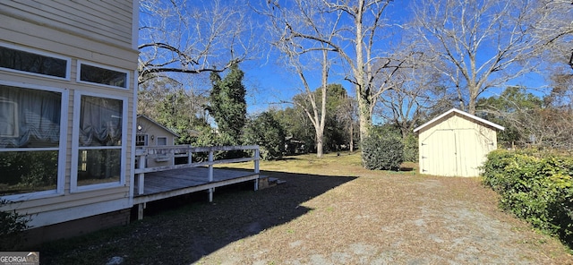 view of yard with a deck and a storage unit