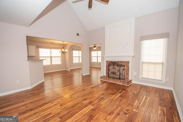 unfurnished living room featuring a fireplace, hardwood / wood-style flooring, and high vaulted ceiling