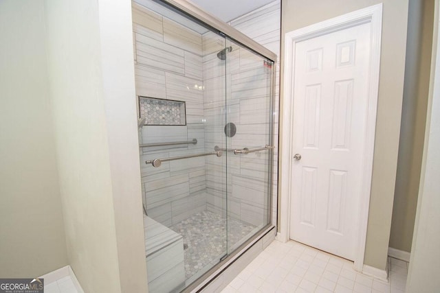 bathroom featuring a shower with door and tile patterned flooring