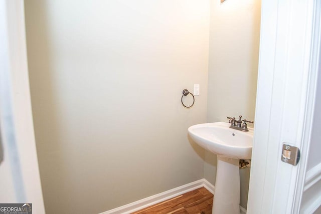 bathroom with sink and wood-type flooring