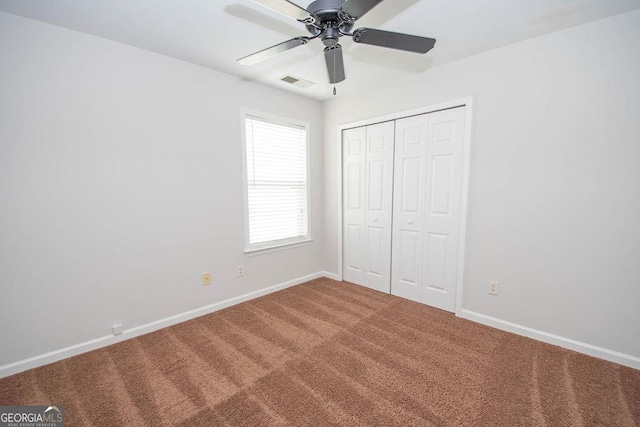 unfurnished bedroom featuring ceiling fan, carpet, and a closet