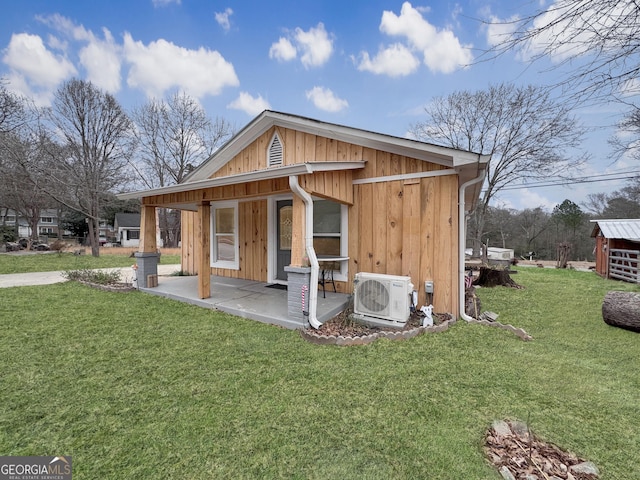 exterior space with ac unit, a patio area, and a front yard