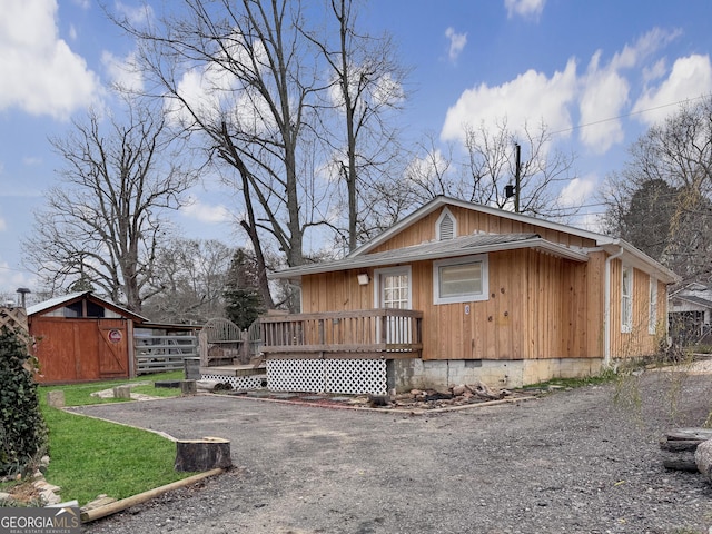 exterior space featuring a deck and a shed