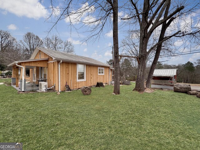 view of property exterior featuring a lawn