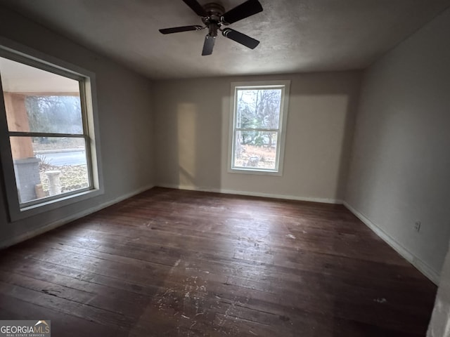 empty room featuring ceiling fan and dark hardwood / wood-style flooring