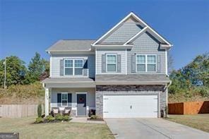 view of front of property featuring a front lawn and a garage