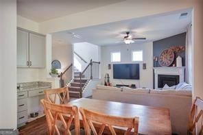 dining room featuring ceiling fan and dark hardwood / wood-style flooring