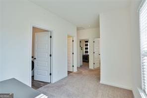 unfurnished bedroom featuring light carpet