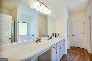 bathroom with hardwood / wood-style floors and vanity