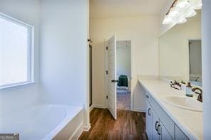 bathroom with shower with separate bathtub, hardwood / wood-style flooring, and vanity