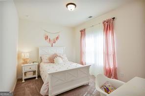 bedroom featuring dark colored carpet