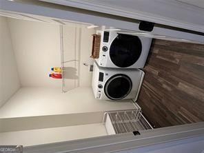 laundry area with stacked washer and dryer