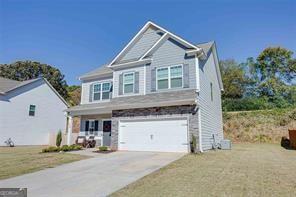 view of front of house with a front lawn and a garage