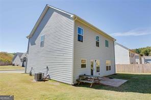 back of house with a patio area, a yard, and central air condition unit