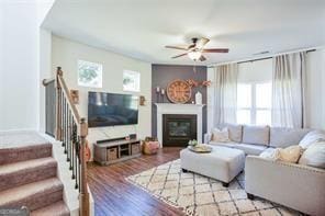 living room featuring ceiling fan and light hardwood / wood-style floors