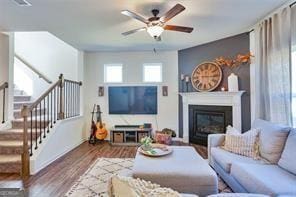 living room featuring ceiling fan and wood-type flooring