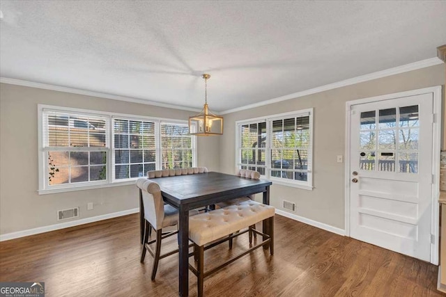 dining room with baseboards, a textured ceiling, visible vents, and dark wood-style flooring