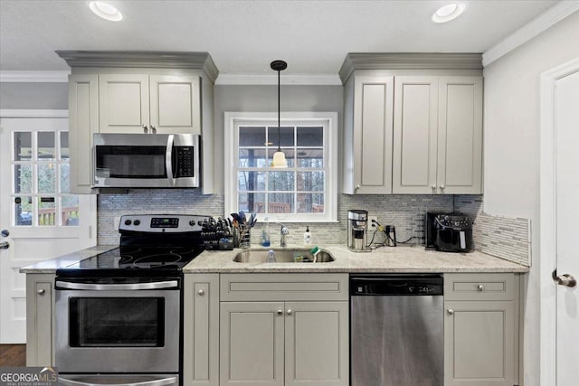 kitchen featuring a sink, light stone countertops, stainless steel appliances, crown molding, and backsplash