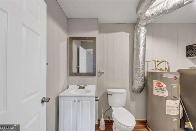 half bath featuring water heater, toilet, wood walls, and vanity