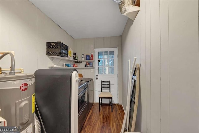 kitchen featuring water heater, washer / clothes dryer, and dark wood-style flooring