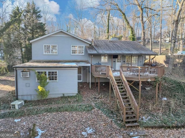 back of property featuring a wall mounted air conditioner, roof with shingles, a deck, and stairs